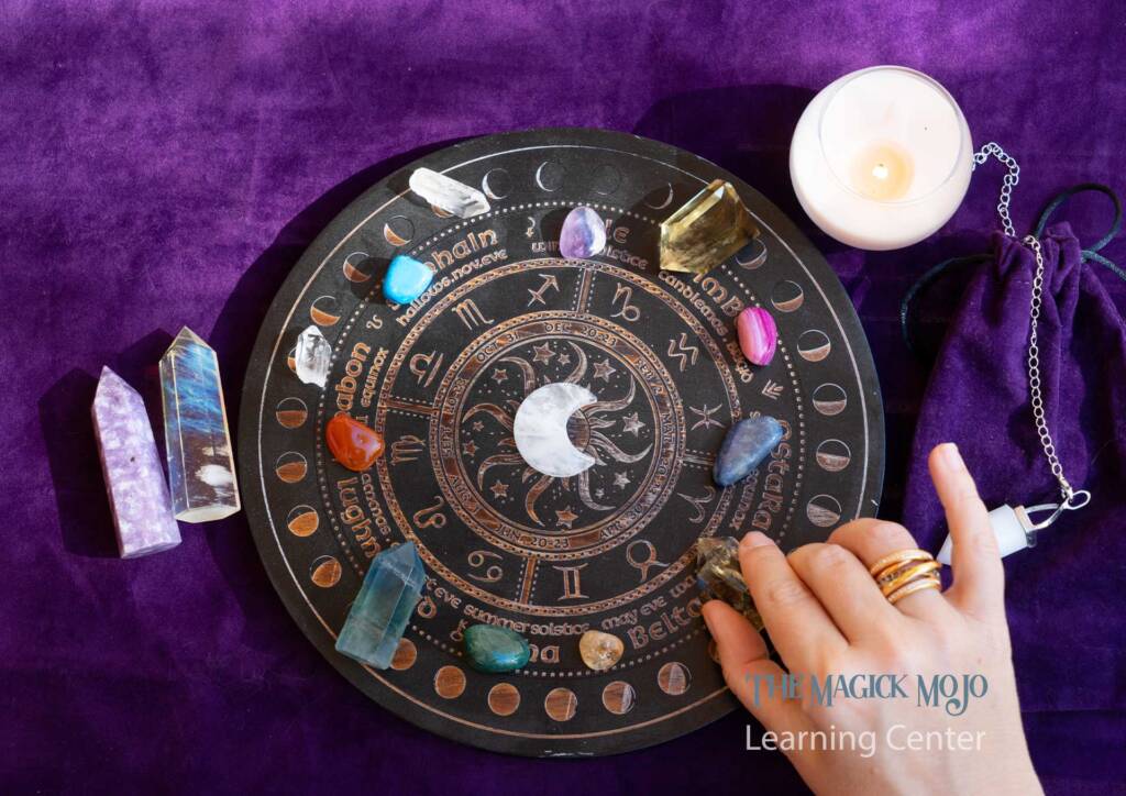 A beautiful array of crystals and stones arranged on a zodiac board with astrological symbols