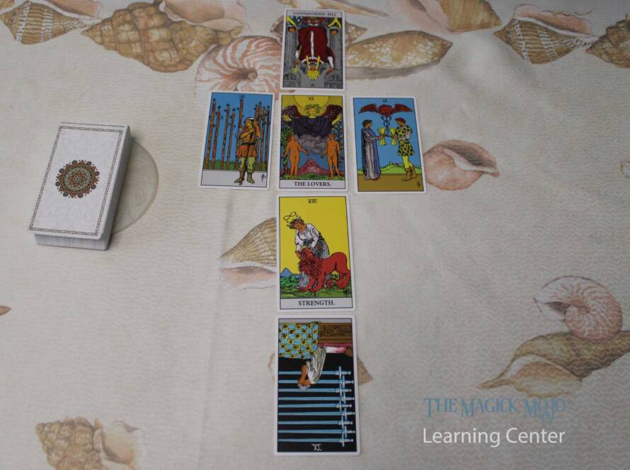A tarot spread with six cards arranged in a V-shape on a shell-patterned background.