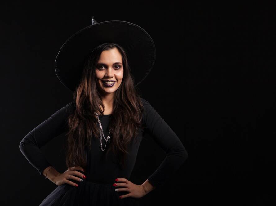 Elegant young woman in witch costume for halloween party