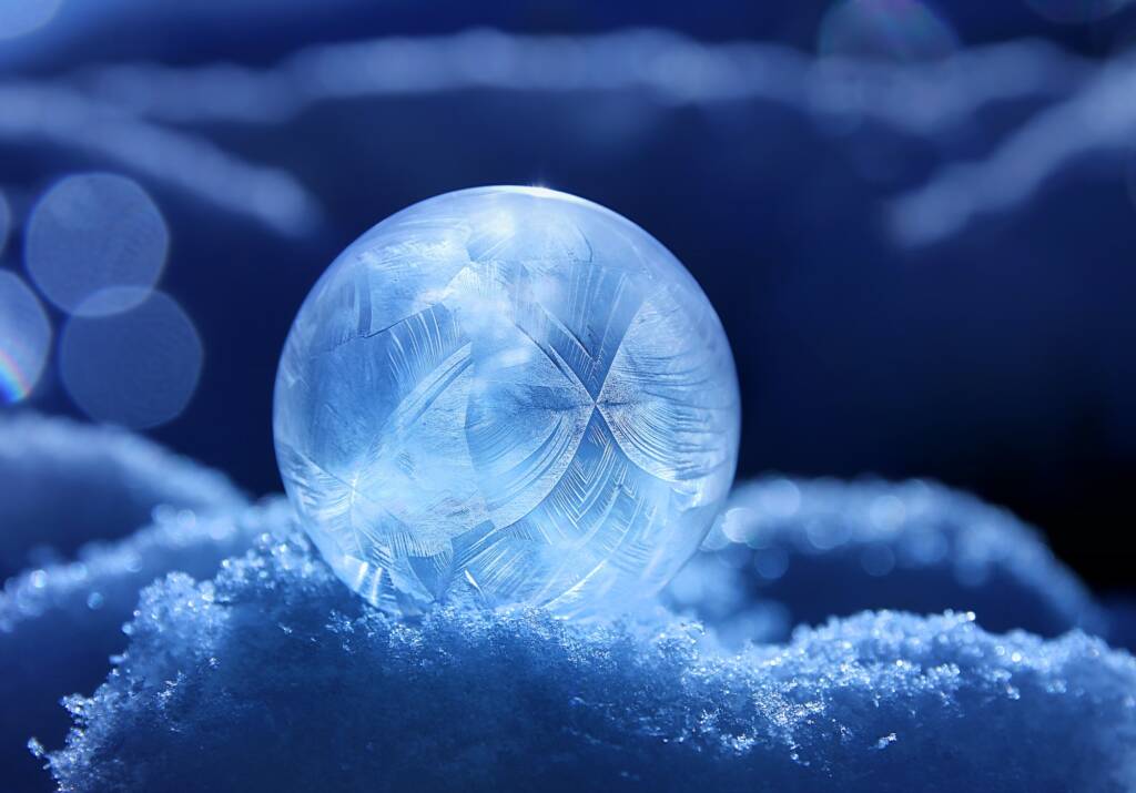 A blue ball of chaotic energy rests amidst a pile of ice crystals, with chaotic sparks emanating from its core.