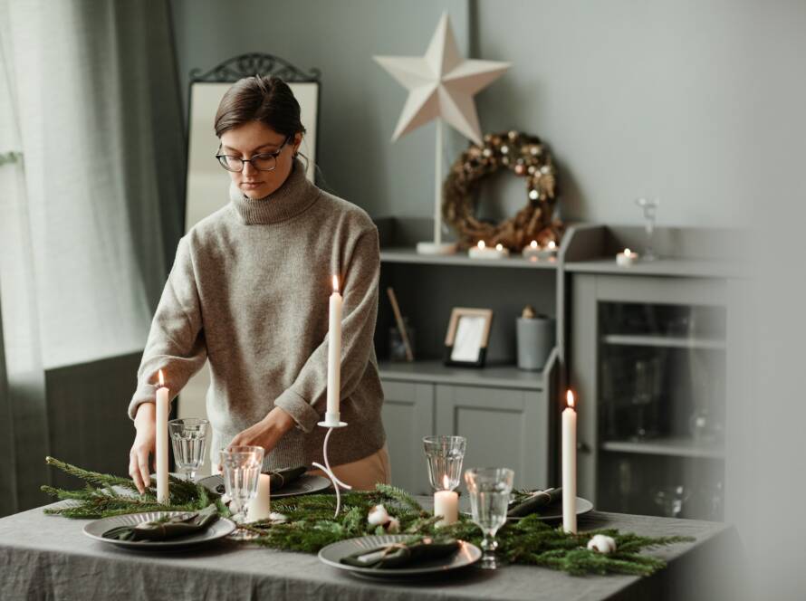Woman Preparing Dining Room for Christmas