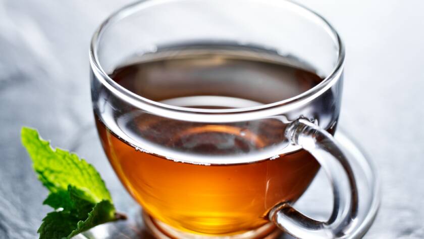 glass of hot tea with mint garnish