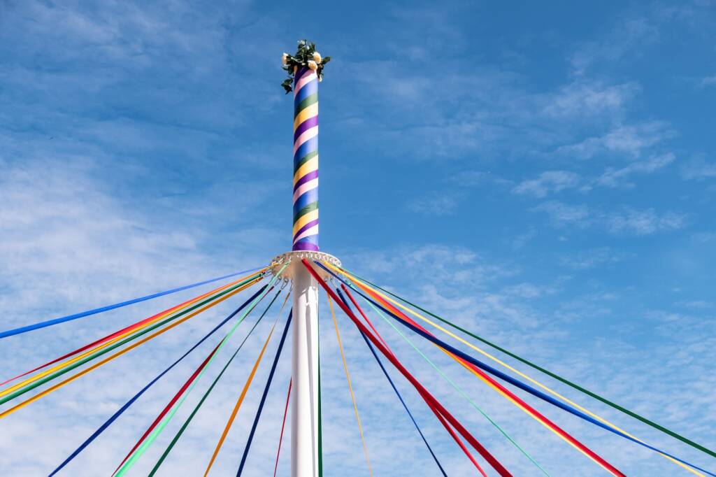 Pole with colored ribbons and flowers on a traditional English Maypole dancing day