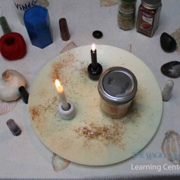 Spellcasting altar with candles, jar, and magical ingredients for a binding spell.