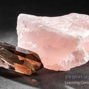 Rose quartz and smoky quartz crystals on a dark background