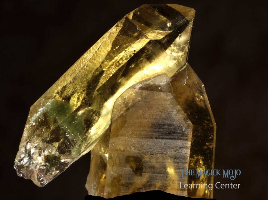 Golden citrine crystal specimen with a dark background.