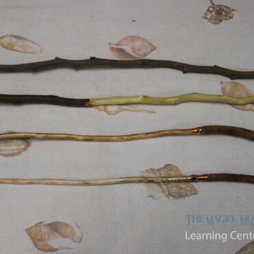 Progression of magic wand crafting, showing raw sticks at various stages of preparation to finished wands with decorative elements.